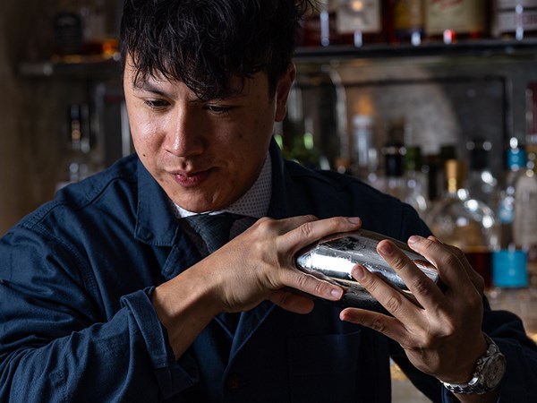 Head mixologist shaking a cocktail shaker in The Maybourne Bar