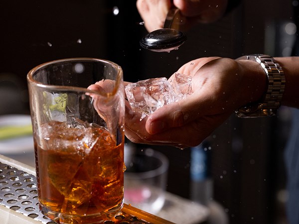 Head mixologist Chris crushing ice to go in a cocktail