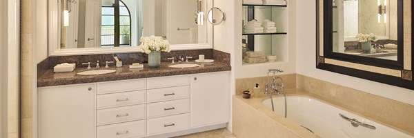 Marble bathroom of the Three-bedroom residence showing a vanity area and bath